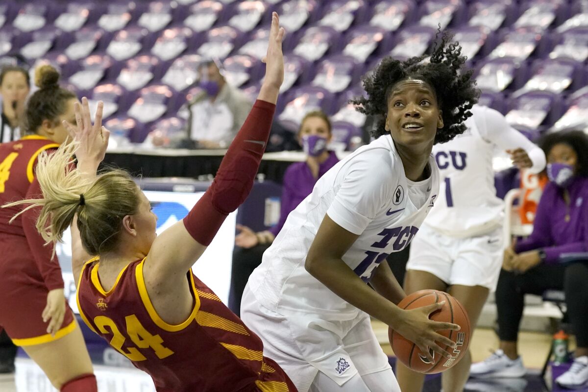 Iowa State guard Ashley Joens (24) is knocked backwards as TCU guard Tavy Diggs (13) positions for a shot in the second half of an NCAA college basketball game in Fort Worth, Texas, Wednesday, Dec. 2, 2020. (AP Photo/Tony Gutierrez)