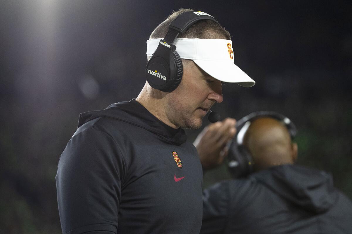 USC coach Lincoln Riley bows his head and walks to the bench during the first half of his team's loss at Notre Dame.