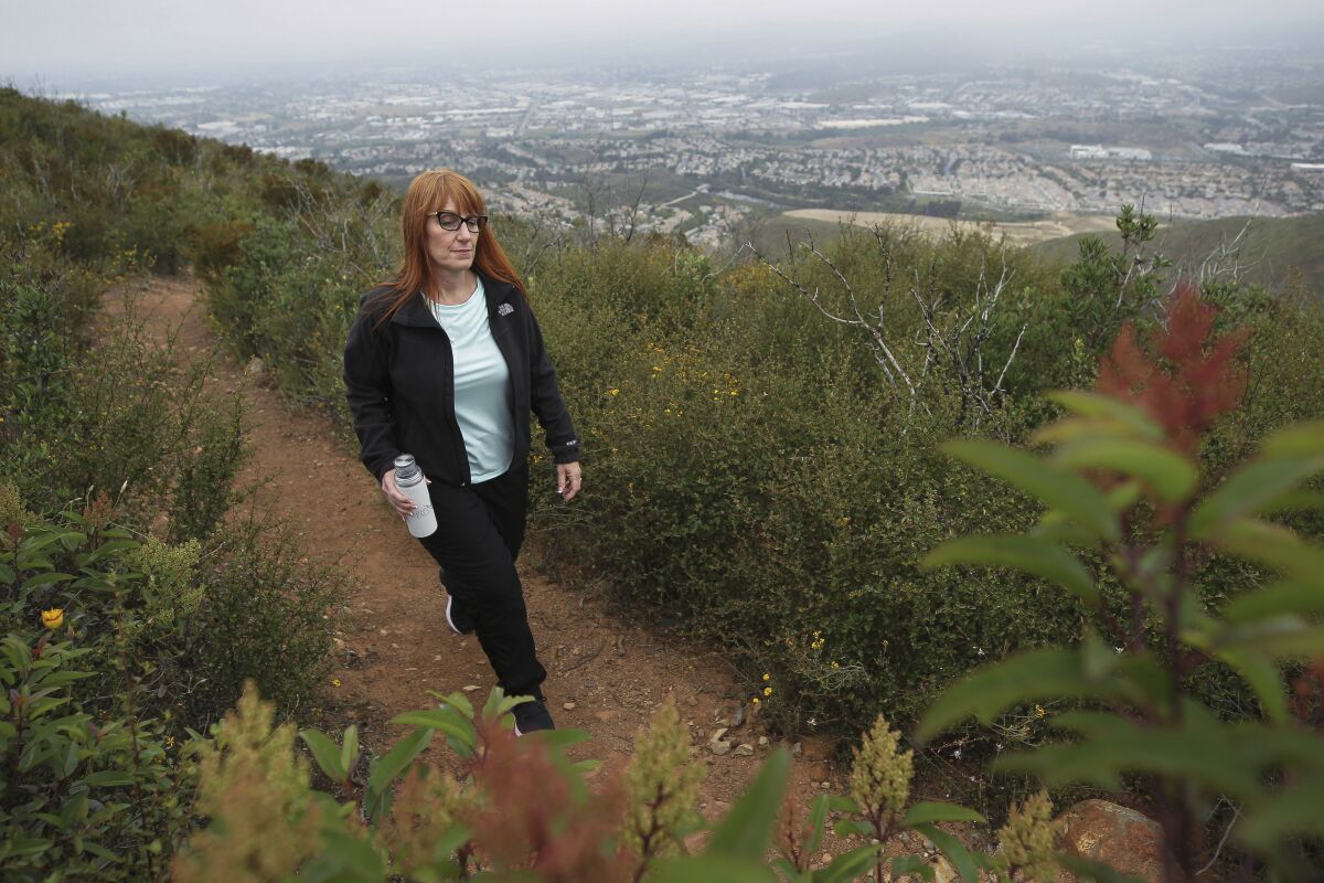 Hiker Rachel Arbuckle on a trail on Double Peak in San Marcos. Her goal: to be healthy enough to donate a kidney to her ailing father.
