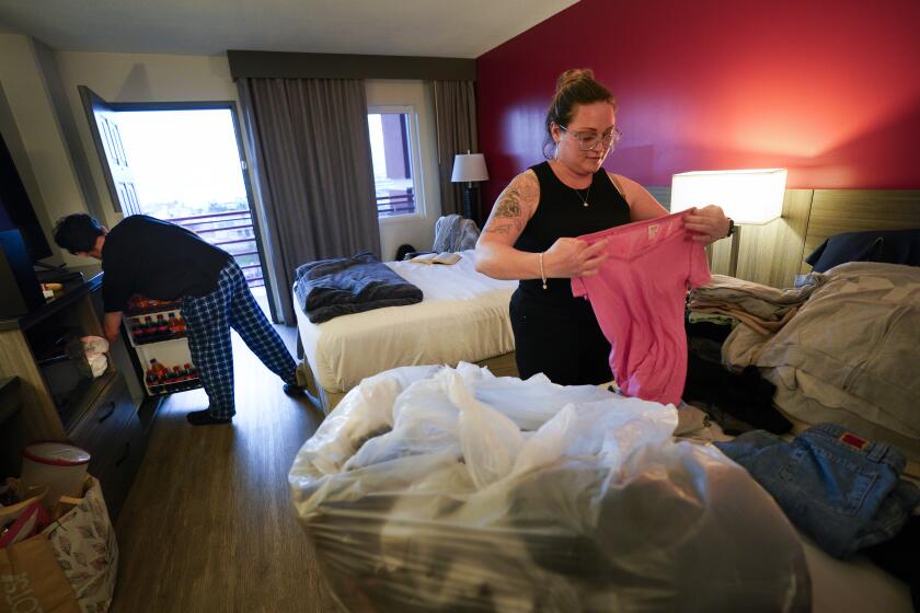National City, CA - February 20: On Tuesday, February 20, 2024, at a local hotel in National City, Brittany LeMoine, 39, and her son, Eduardo Cabrera, 18, begin to settle into their new hotel room. Up until last month's flood on January 22nd, LeMoine, along with her two children, were living with her mother on Beta Street. However because of the flood done to their home, the family spent their first three nights at the Red Cross shelter setup at Lincoln High School. And from there, they were able to relocate to a local hotel. (Nelvin C. Cepeda / The San Diego Union-Tribune)