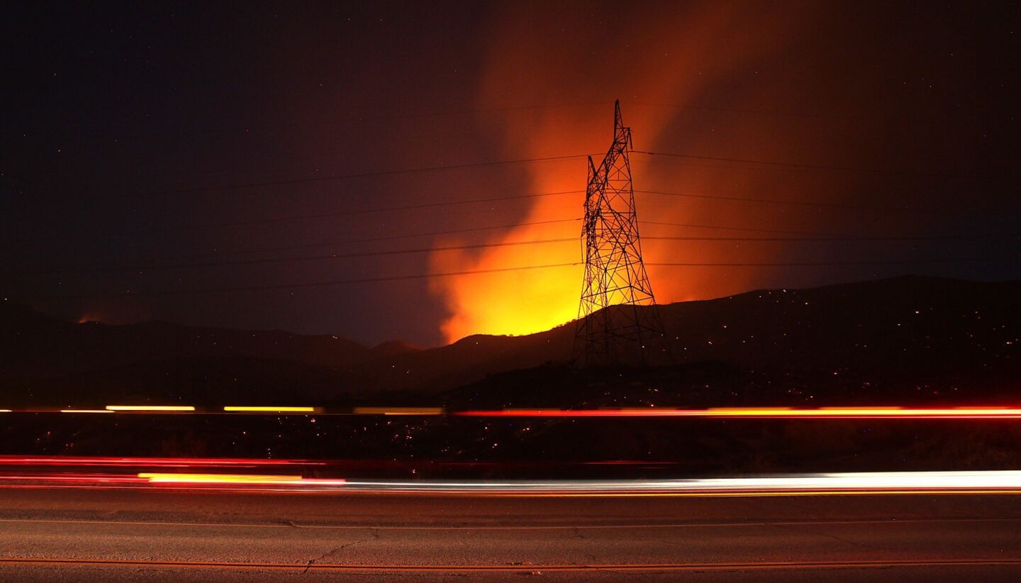Flames from the Powerhouse fire burn along San Francisquito Road in the Angeles National Forest near Green Valley.