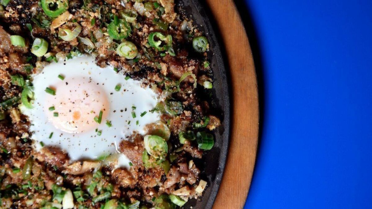 Sizzling pork sisig with egg, a family recipe adapted by Charles Olalia for his restaurant Ma'am Sir