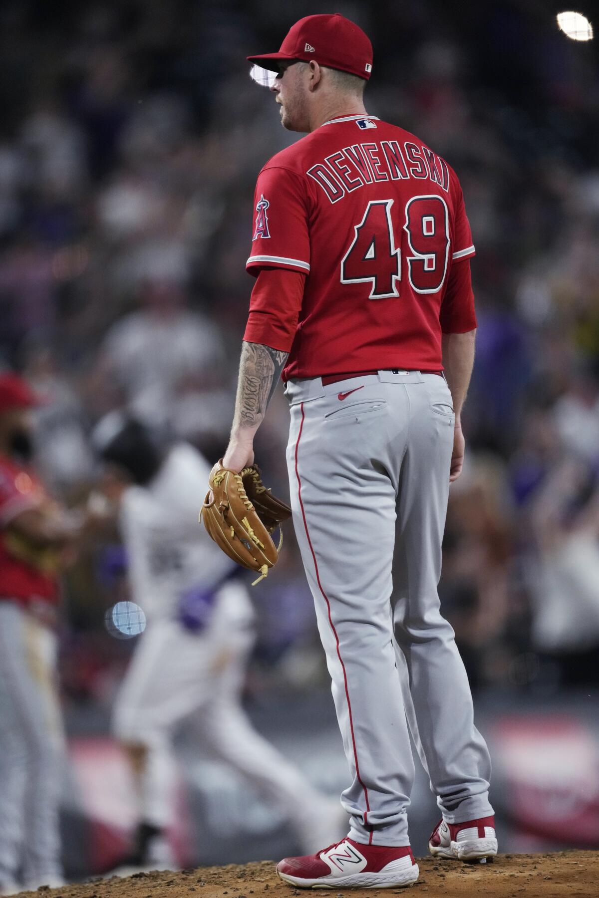 Angels reliever Chris Devenski stands on the mound as the Rockies' Elias Díaz rounds the bases on a grand slam June 23, 2023.