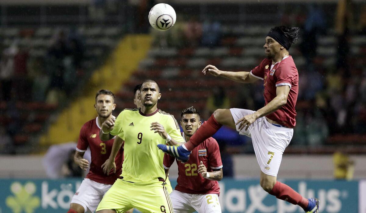 Costa Rica's Cristian Bolanos, right, in action against Venezuela's players during their friendly match on May 27.