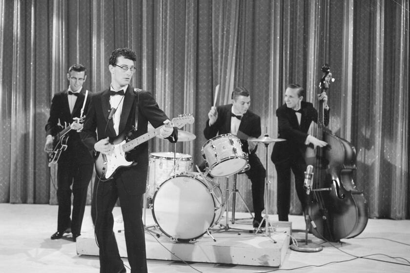 American rock music pioneer Buddy Holly (1936 - 1959) (second left) and his band The Crickets perform on Ed Sullivan's CBS variety show 'Toast of the Town,' New York, December 1, 1957. The Crickets were (left to right) rhythm guitarist Niki Sullivan (1937 - 2004), drummer Jerry Allison, and bassist Joe B. Mauldin. (Photo by CBS Photo Archive/Getty Images)