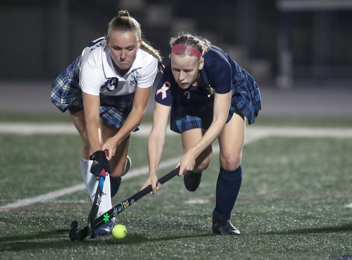 Marina's Emmi Burdine, right, moves on the attack as Newport Harbor's Maia Schimmelpfennig tries to steal.