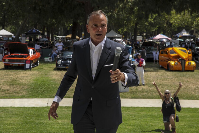 Mayoral candidate Rick Caruso holds a microphone