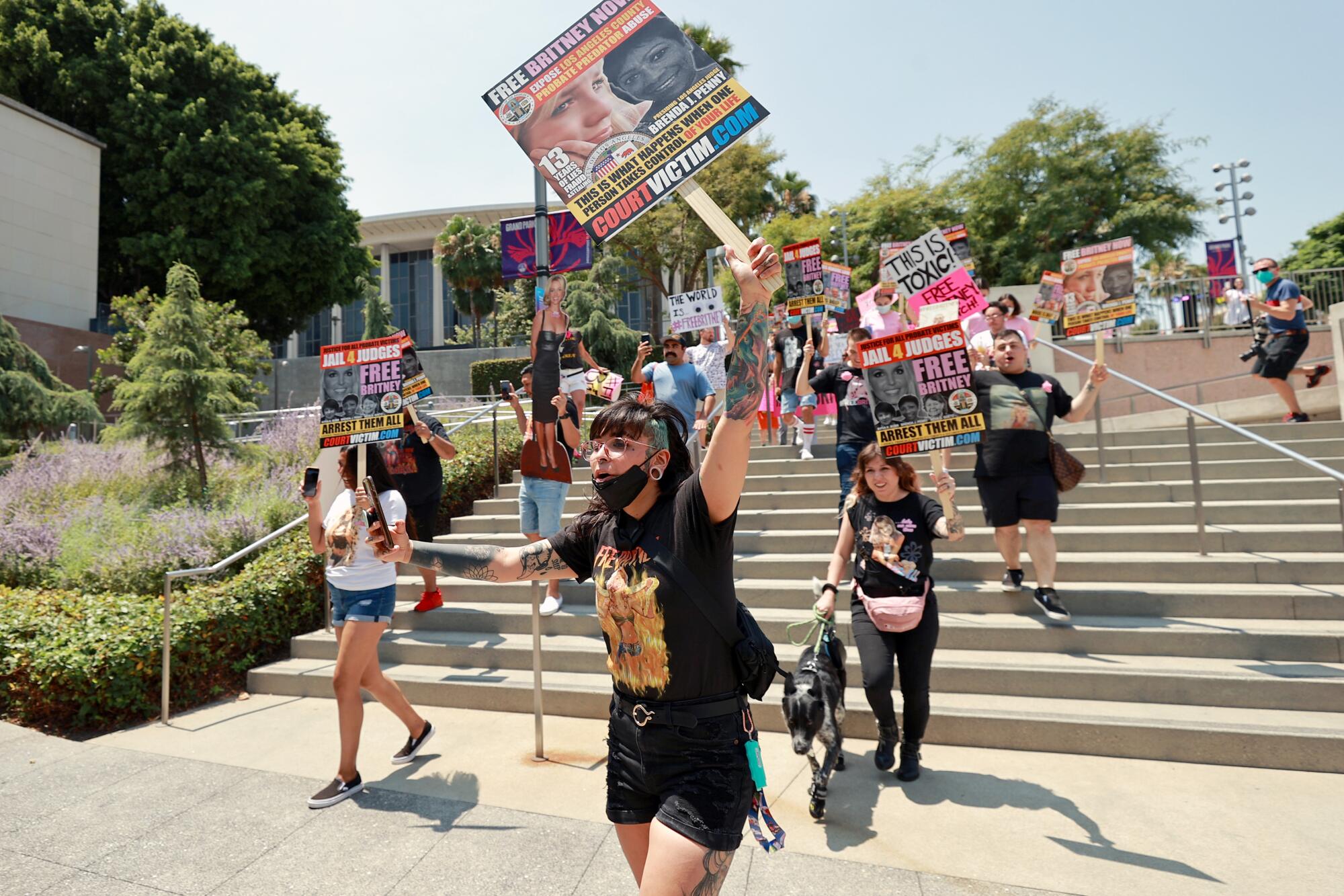 Protesters walk down steps at a #FreeBritney rally at Stanley Mosk Courthouse. 