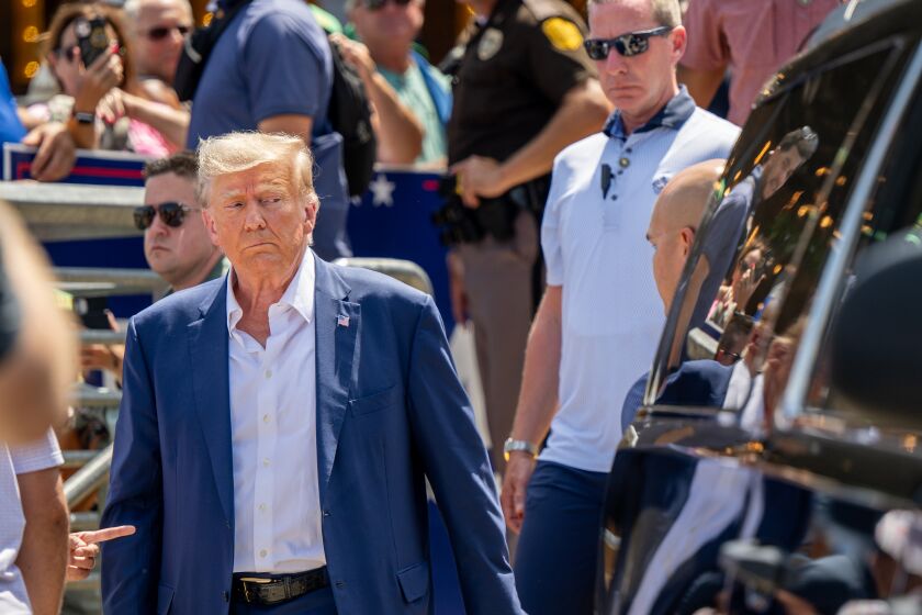 DES MOINES, IOWA - AUGUST 12: Republican presidential candidate and former U.S. President Donald Trump is directed to his vehicle after speaking at the Steer N' Stein bar at the Iowa State Fair on August 12, 2023 in Des Moines, Iowa. Republican and Democratic presidential hopefuls, including Florida Gov. Ron DeSantis, former President Donald Trump are visiting the fair, a tradition in one of the first states to hold caucuses in 2024. (Photo by Brandon Bell/Getty Images)