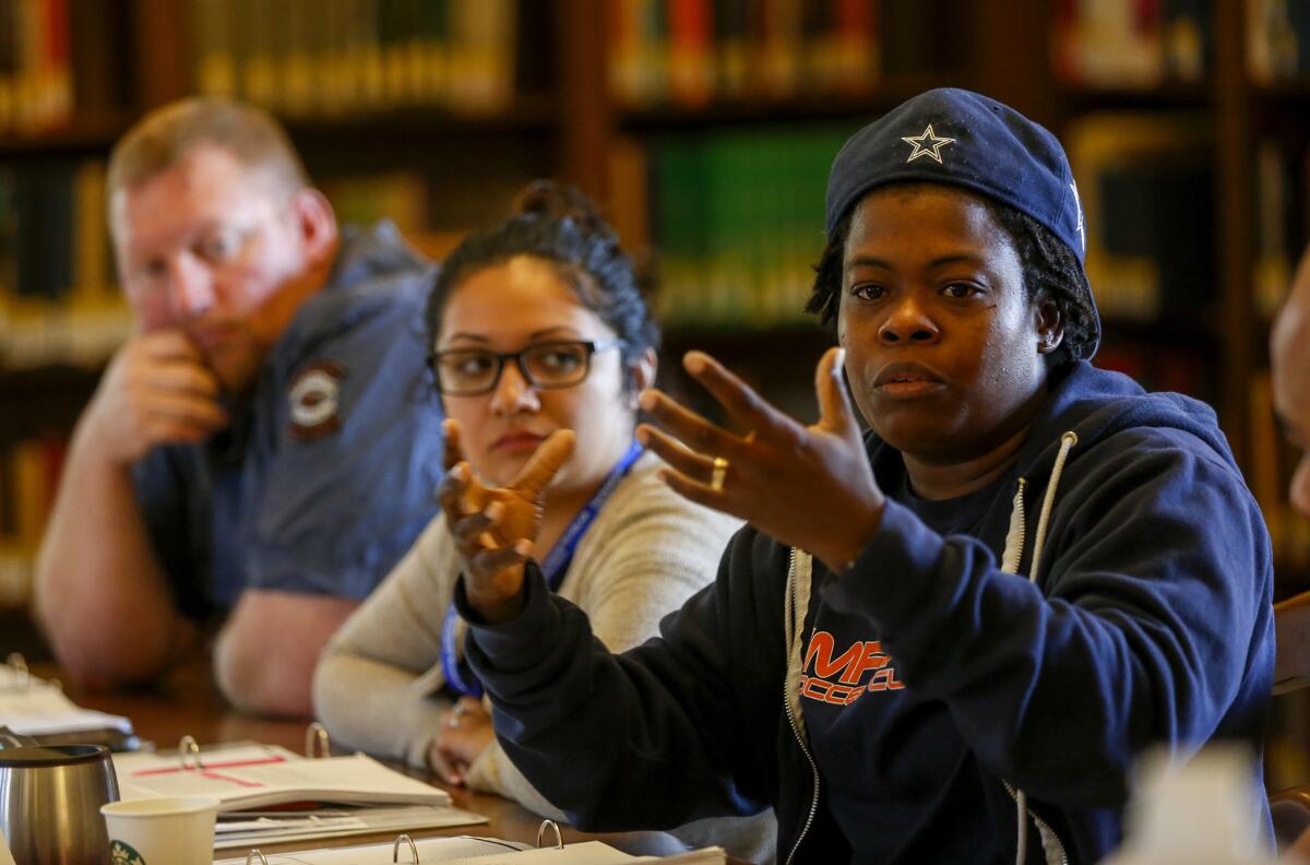 From left, Jacob Wessel and Carmen Molina listen to fellow veteran Charena Lafayette during a group discussion in the Warrior-Scholar Project at USC. The program prepares veterans for higher education.