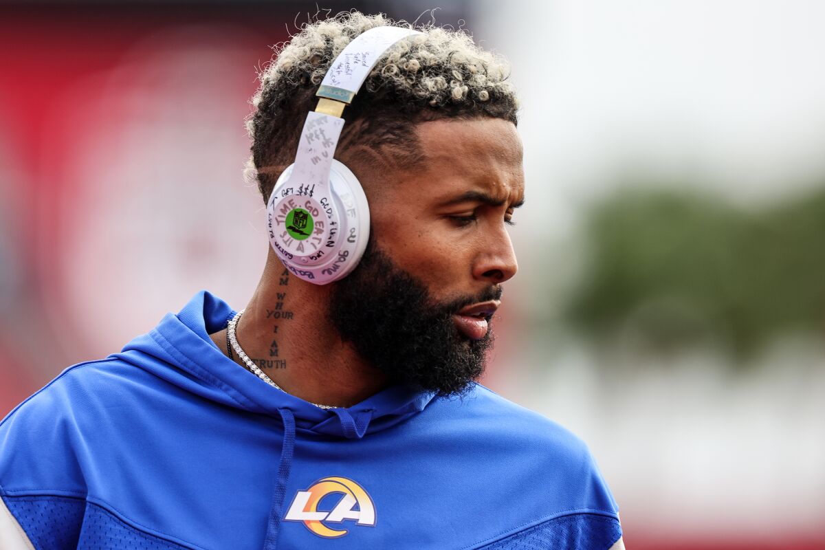 Rams receiver Odell Beckham Jr. wears headphones while warming up before a playoff game against Tampa Bay.