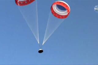 In this image made from a video provided by NASA parachutes guide the Starliner capsule to the ground after a test of Boeing's crew capsule's launch abort system in White Sands Missile Range in N.M., on Monday, Nov. 4, 2019. The capsule carried no astronauts Monday morning, just a test dummy. (NASA via AP)
