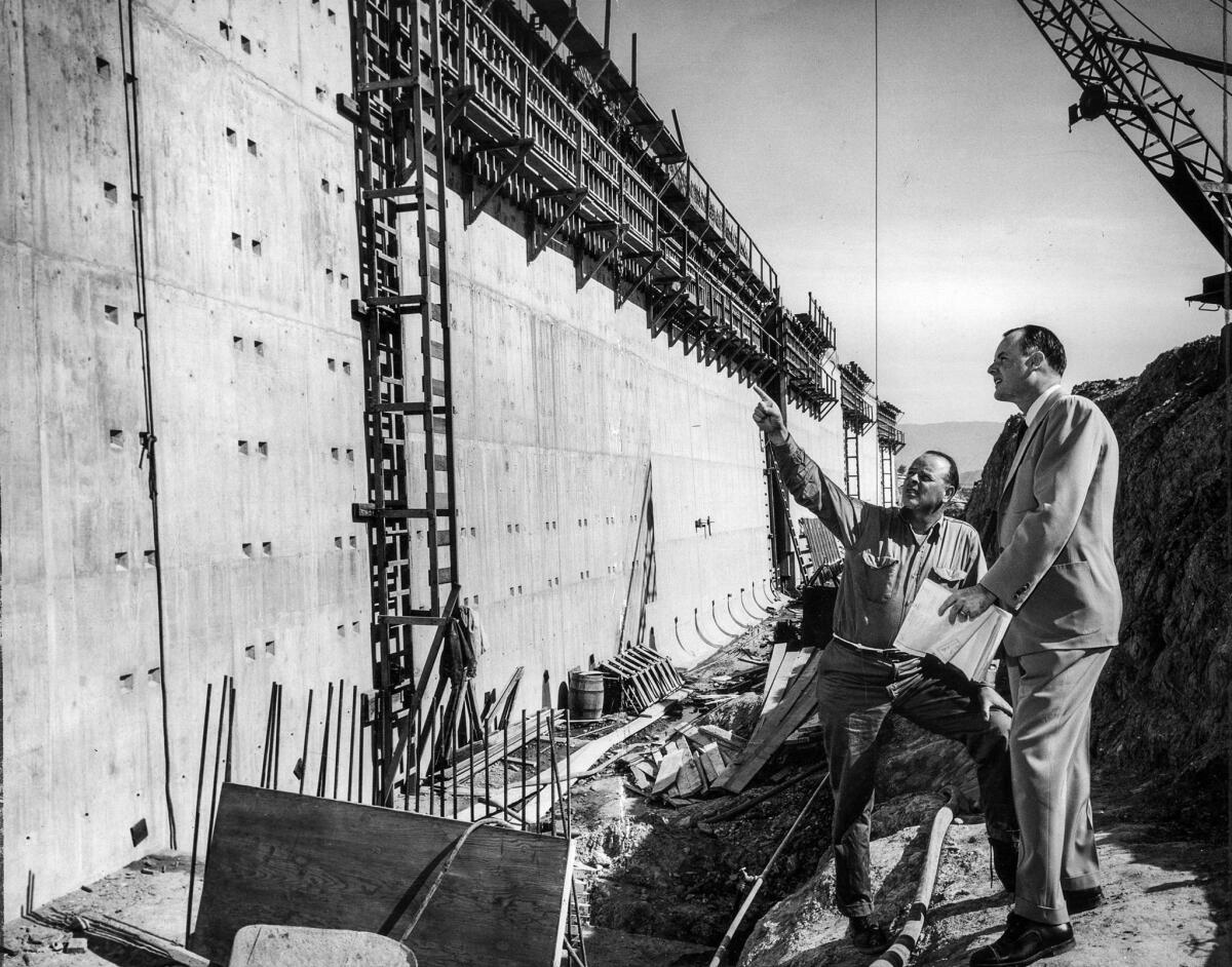 March 10, 1954: Contractor M. J. Brock Jr., left, and Superintendent Bill Lassetter check the progress of the Ft. Moore Pioneer Memorial.