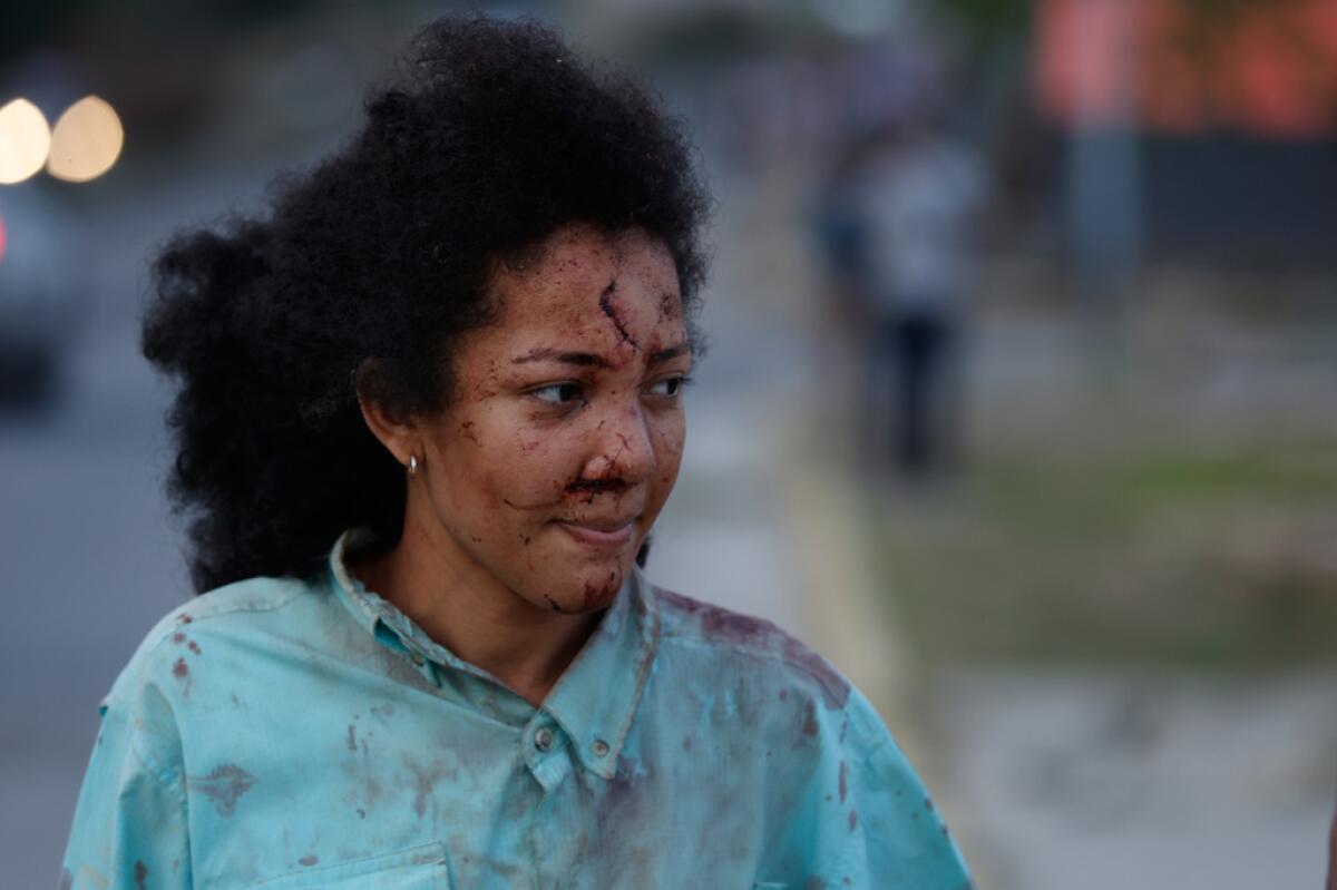 Una mujer herida camina por La Guaira,