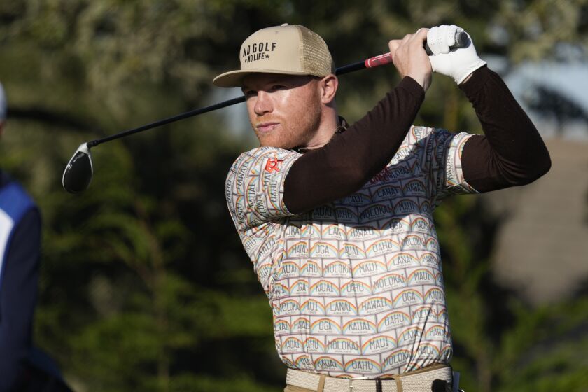 Canelo Alvarez, of Mexico, follows his drive from the second tee of the Monterey Peninsula Country Club Shore Course.