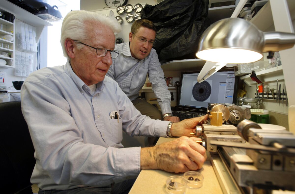 Stolpe watches as his father, John C. Stolpe, a retired research engineer, works on creating molds in the development of digital technology at Advanced Artificial Eyes in Tarzana.