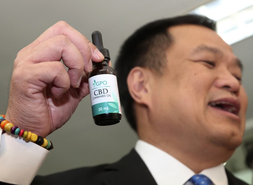 FILE - Thailand's Public Health Minister Anutin Chanvirakul shows off a bottle of extracted cannabis oil during a press conference at his ministry in Bangkok, Thailand, Wednesday, Aug. 7, 2019. Thailand on Tuesday, Jan. 25, 2022, became the first country in Asia to approve the de facto decriminalization of marijuana, as its anti-narcotics agency agreed to have the Health Ministry drop cannabis from its list of controlled drugs. (AP Photo/Sakchai Lalit, File)