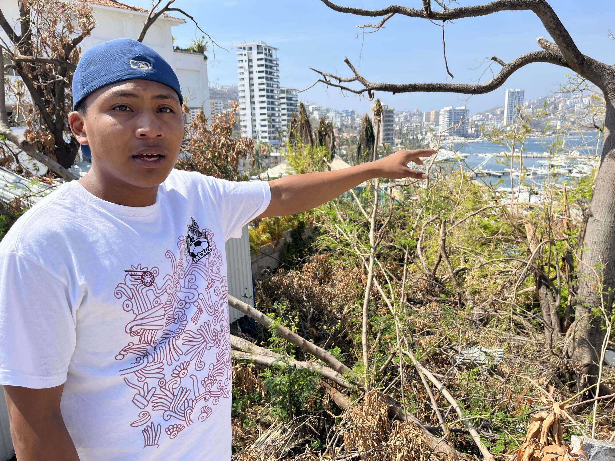 A young man points toward the bay in Acapulco
