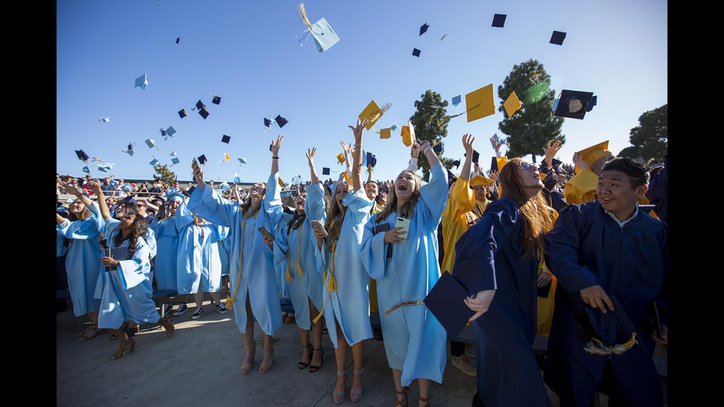 Graduates toss their caps in the air during the 2017 commencement ceremony for Marina High School on Thursday, June 15.