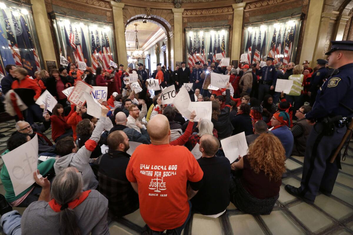 Labor supporters at the Michigan State Capitol protest anti-union laws passed in 2012 in the heart of the American labor movement.