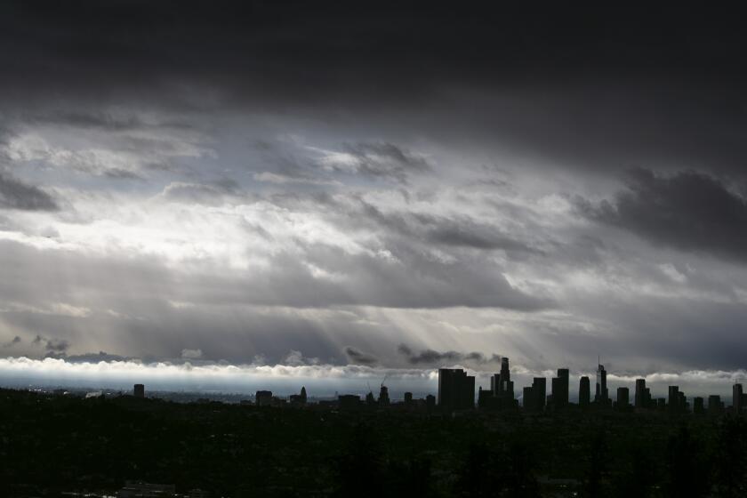 LOS ANGELES, CA - DECEMBER 28: Clouds drift over the L.A. Basin as rain falls during the last storm of the year in a view from the Griffith Observatory on Monday, Dec. 28, 2020 in Los Angeles, CA. (Brian van der Brug / Los Angeles Times)