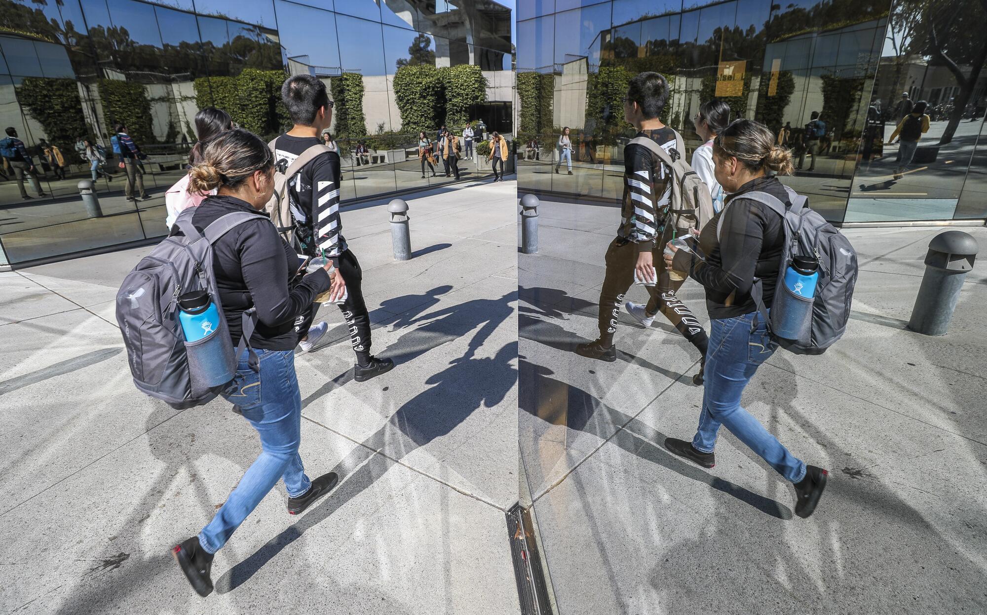 Students walk toward the entrance of the Geisel Library at the UCSD campus in 2019.