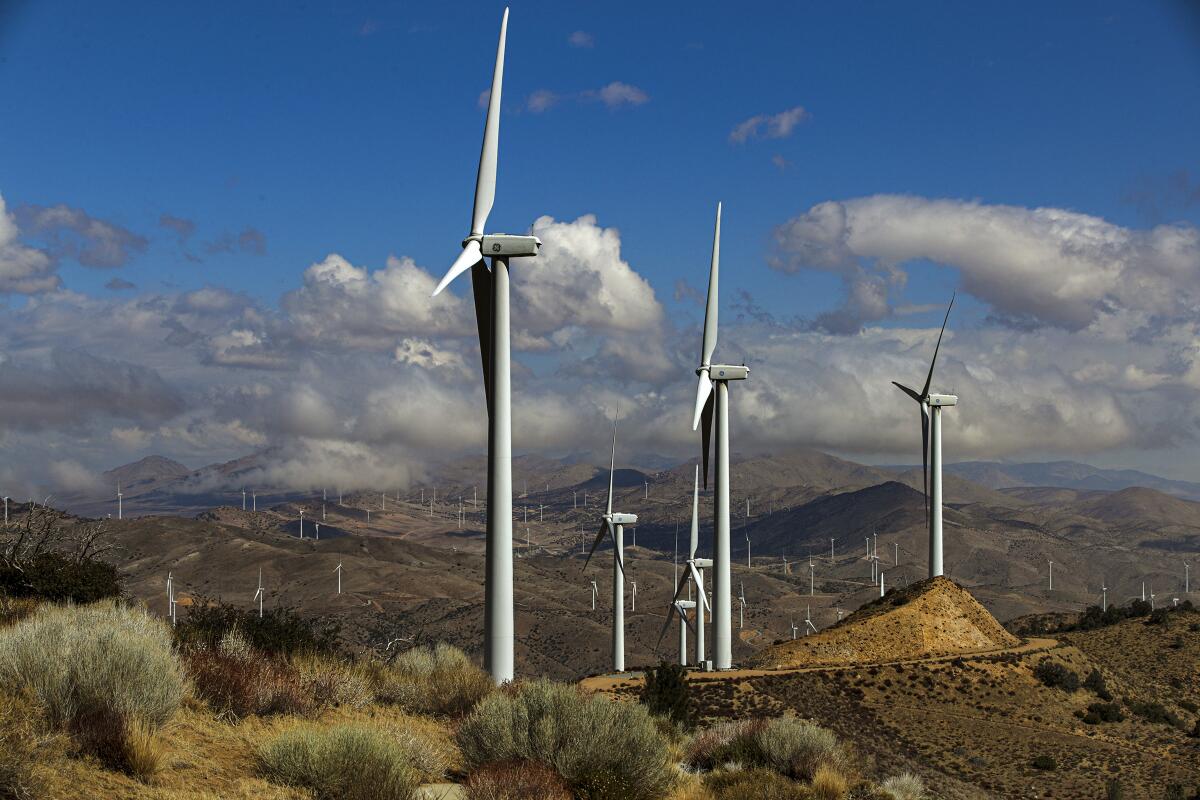 Wind turbines rise above the Tehachapi Mountains.