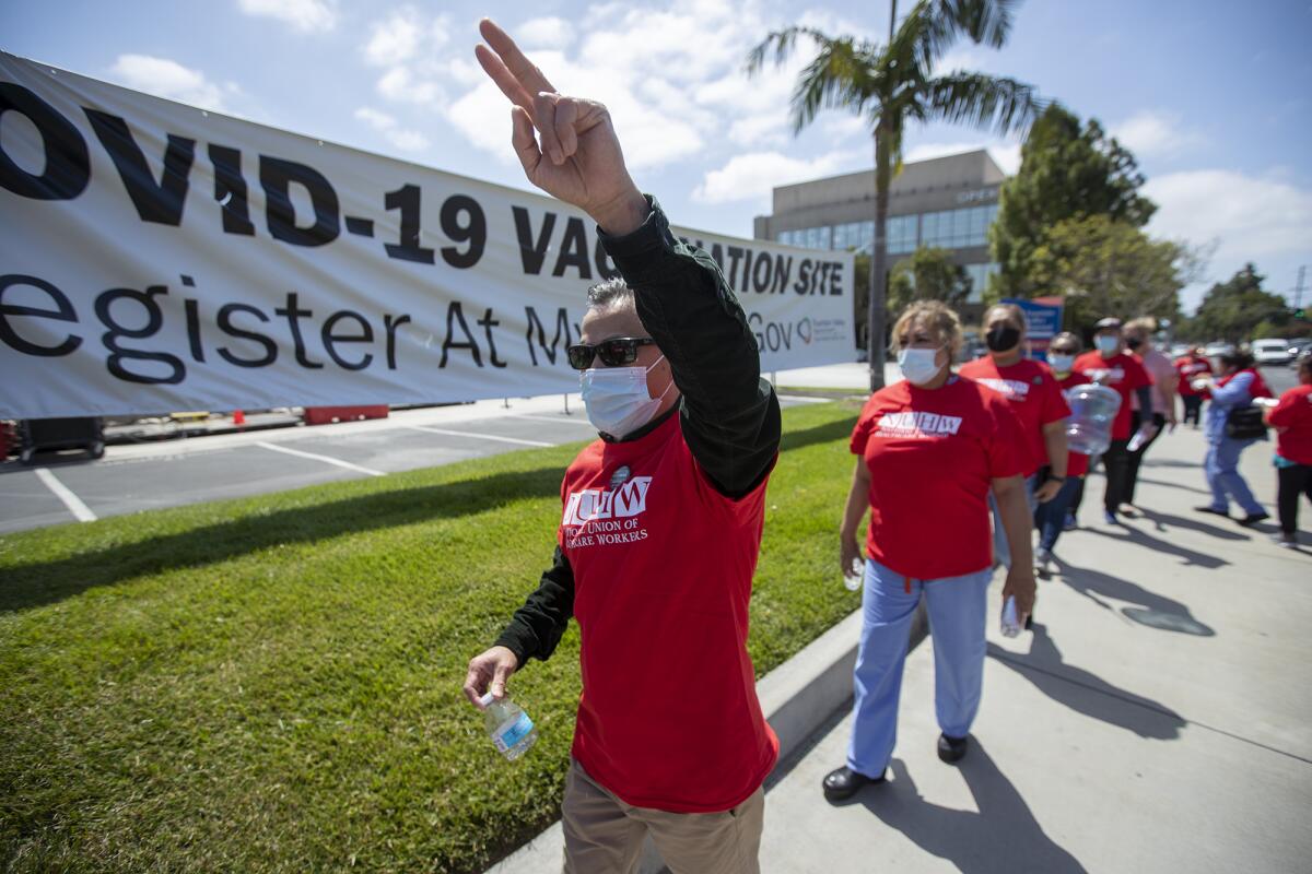Sony Pham, an ultrasound technician, chants during a rally outside the Fountain Valley Regional Hospital & Medical Center.