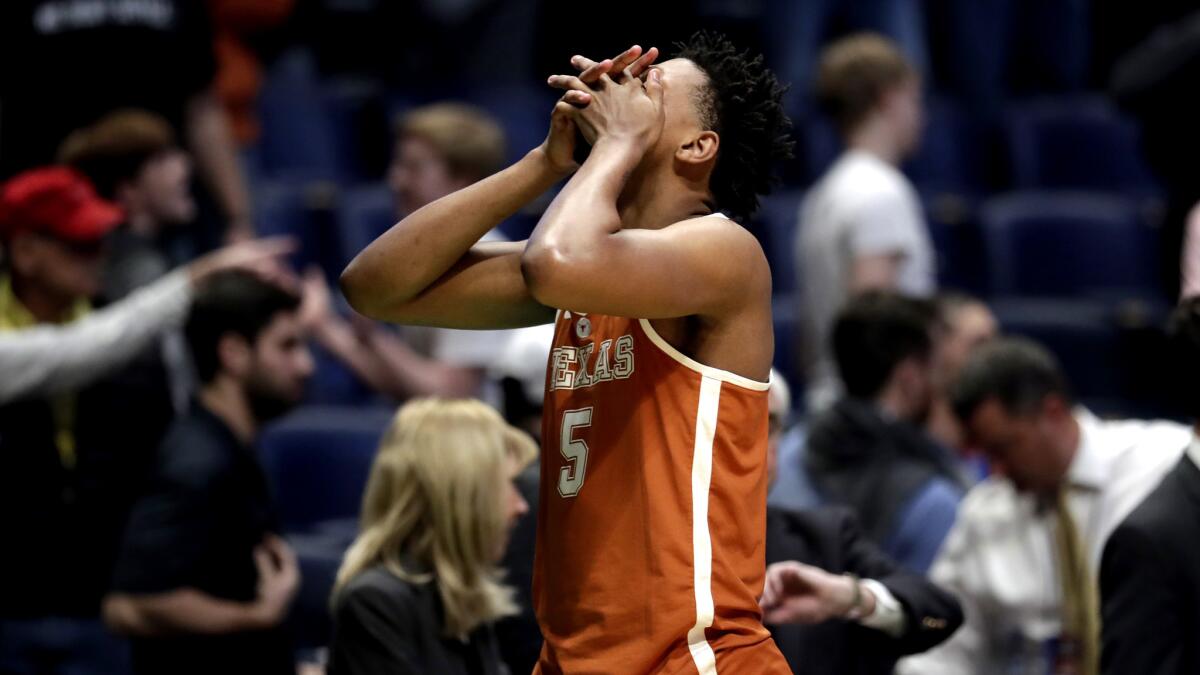 Texas forward Royce Hamm Jr. reacts after losing in overtime to Nevada on Friday.