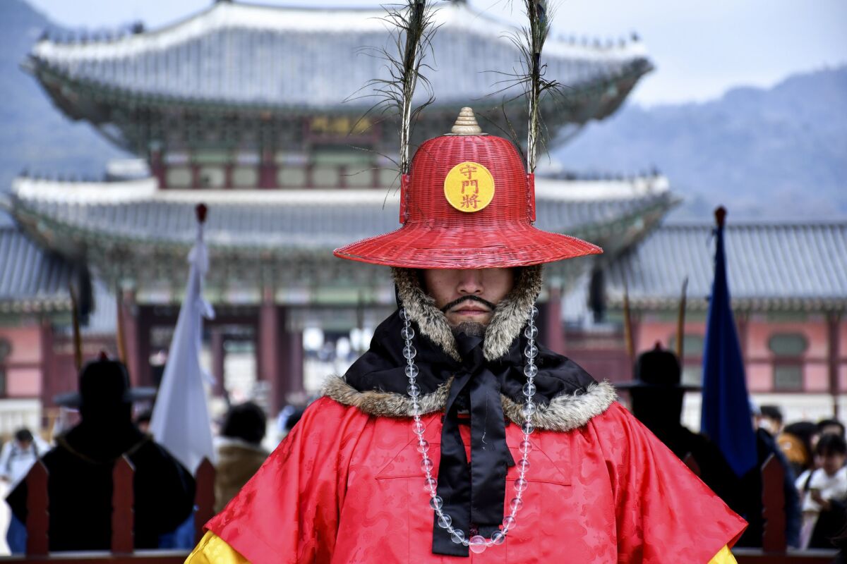 Twice daily, crowds gather for the changing of the guard at Gwanghwamun Gate of Gyeongbokgung Palace, Seoul. (The guards are actors with fake mustaches.)