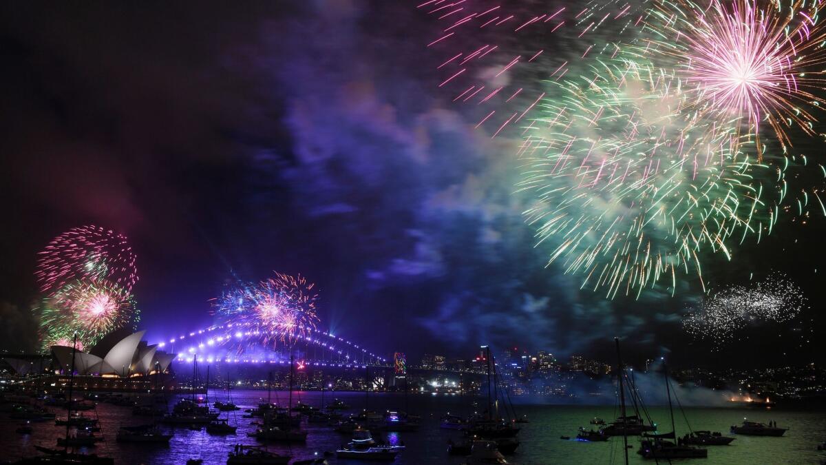 Fireworks explode over Sydney Harbor during New Year's Eve celebrations.