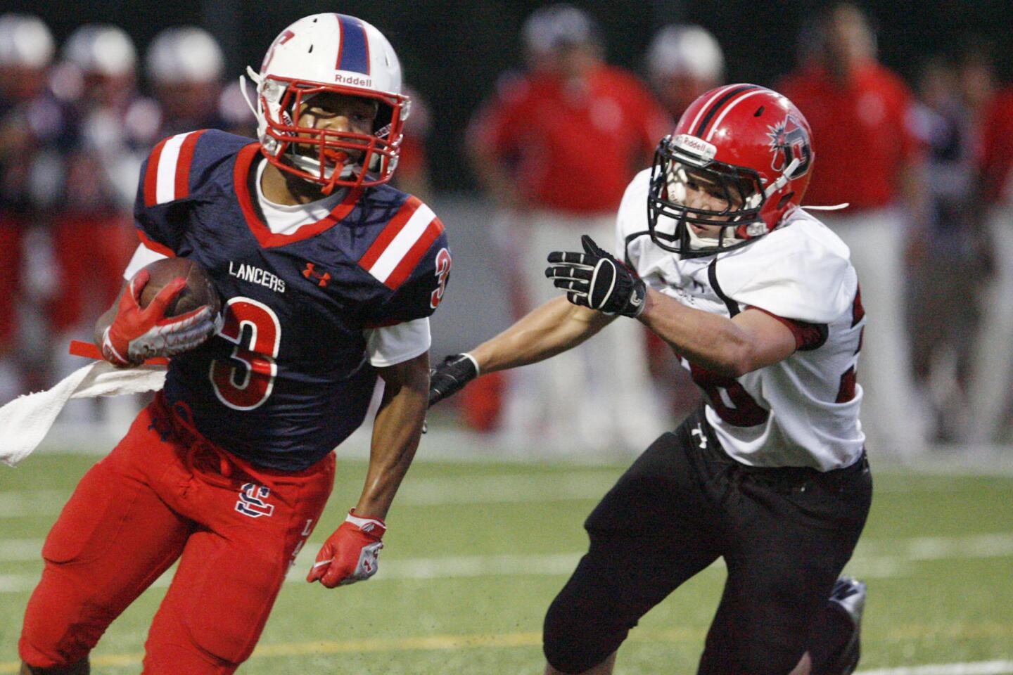 La Salle's Amir Evans, left, runs with the ball while Glendale's Sam Peplow tries to tackle Evans during a game at La Salle High School in Pasadena on Friday, on August 31, 2012.