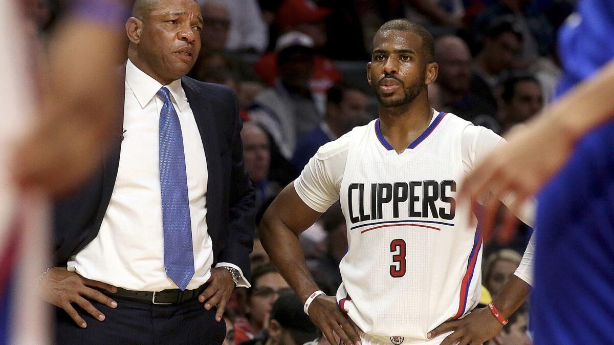 Clippers point Chris Paul, right, did not play Friday night because of a strained hamstring.