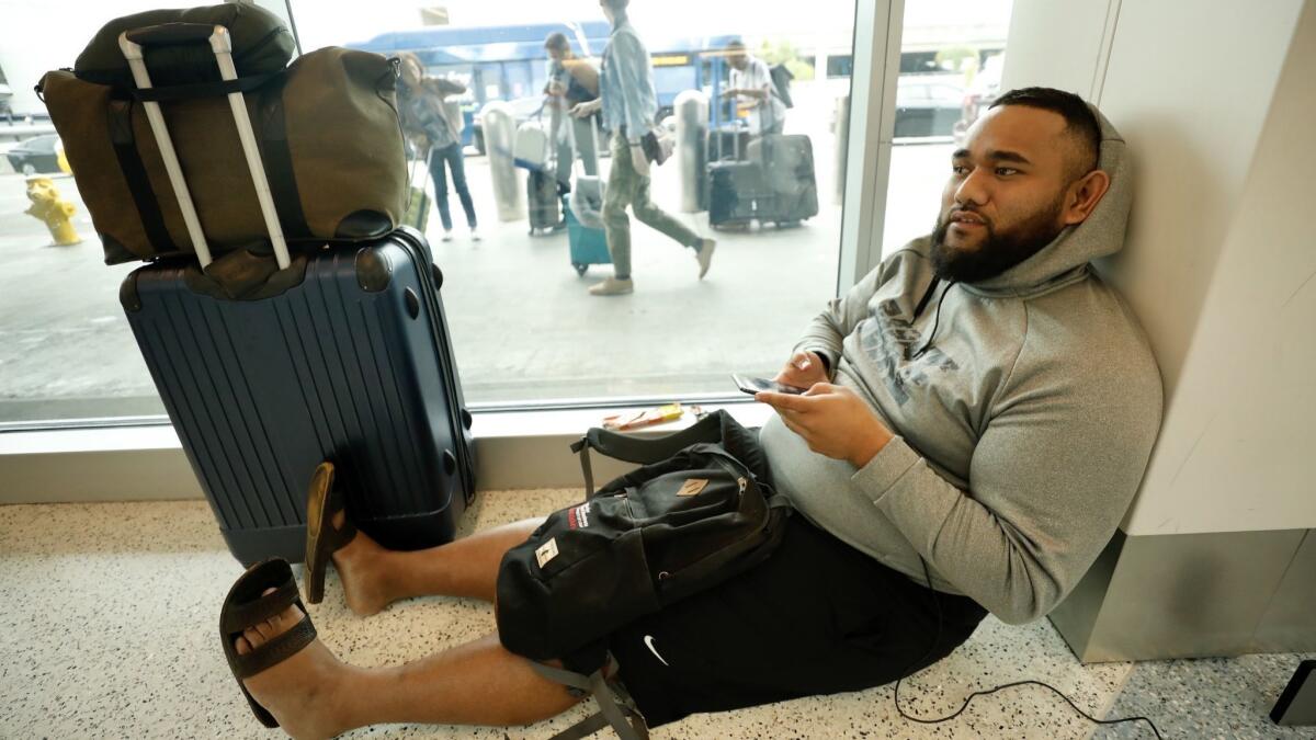 Freddy Lafoou, 25, from the San Francisco Bay Area, slept in Terminal 1 overnight waiting for a Southwest Airlines flight to Salt Lake City. He left San Francisco at 6 p.m. Wednesday and expects to arrive in Salt Lake at 6 p.m. Thursday.