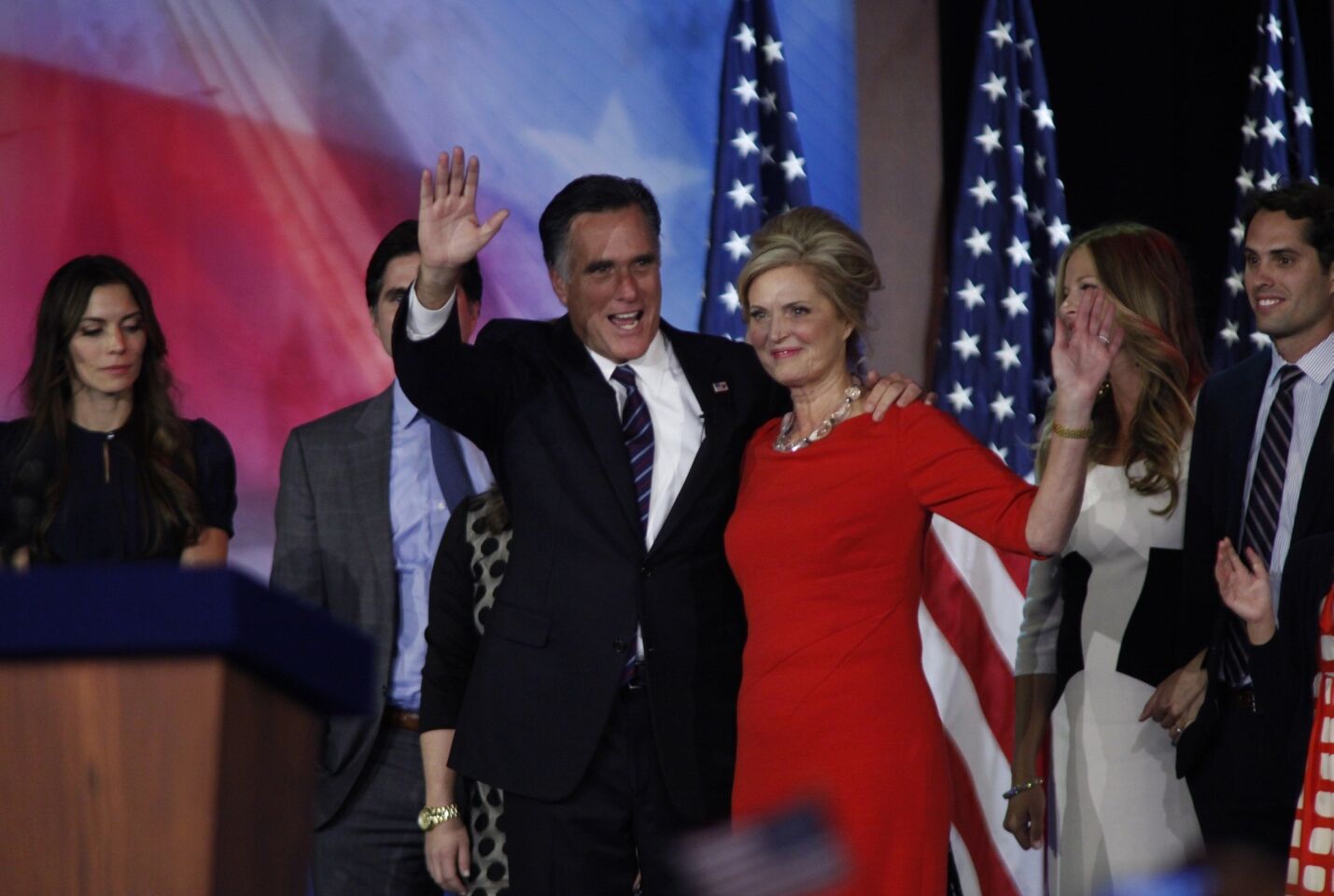 GOP presidential challenger Mitt Romney and wife Ann wave to supporters at the Boston Convention Center.
