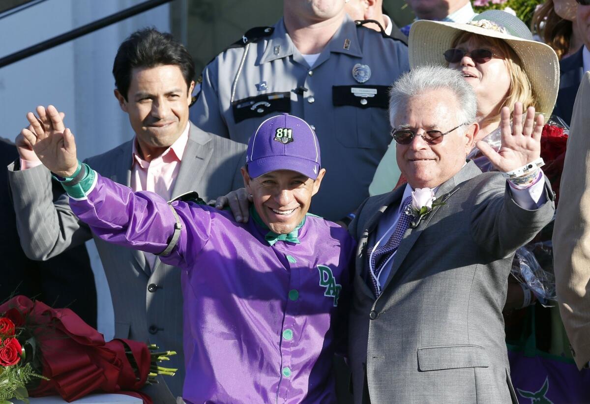 Jockey Victor Espinoza, left, and trainer Art Sherman, right, celebrate California Chrome's victory in the 140th Kentucky Derby on Saturday at Churchill Downs.
