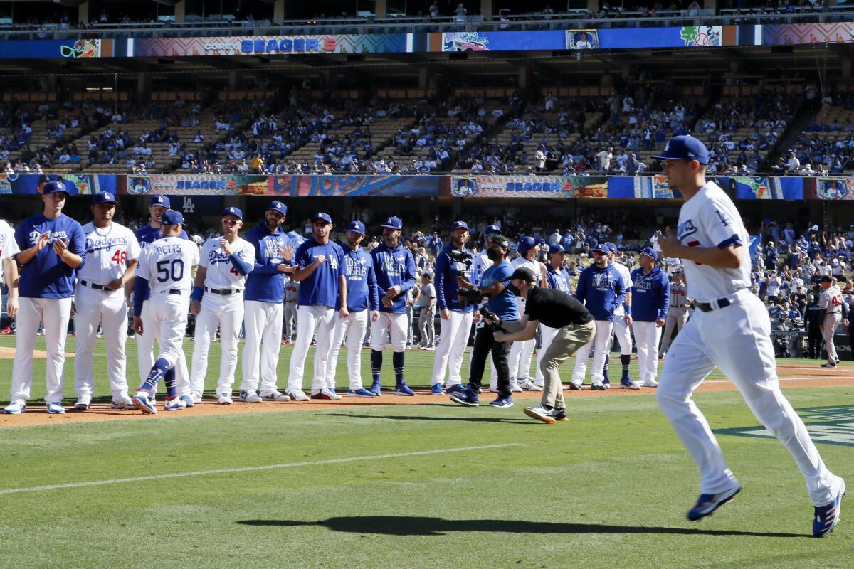 Dodgers shortstop Corey Seager runs onto the field.
