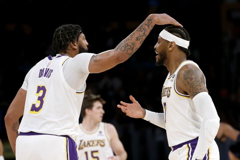 Los Angeles Lakers forwards Carmelo Anthony, right, is greeted by Anthony Davis (3) after Anthony scoring a three-point basket against the Memphis Grizzlies during the first half of an NBA basketball game in Los Angeles, Sunday, Oct. 24, 2021. (AP Photo/Ringo H.W. Chiu)
