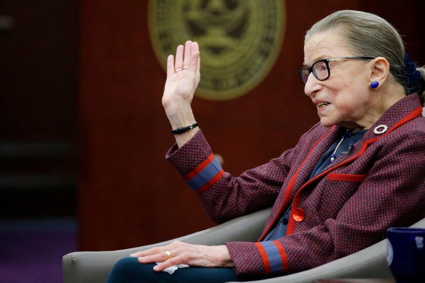 Supreme Court Justice Ruth Bader Ginsburg waves goodbye to those who came to listen and participate in her "fireside chat" in the Bruce M. Selya Appellate Courtroom at the Roger William University Law School on Tuesday, Jan. 30, 2018, in Bristol, R.I. (AP Photo/Stephan Savoia)