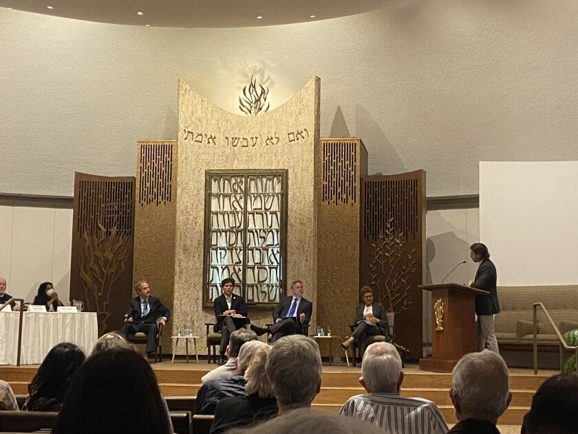 Mayoral candidates are sitting on the stage