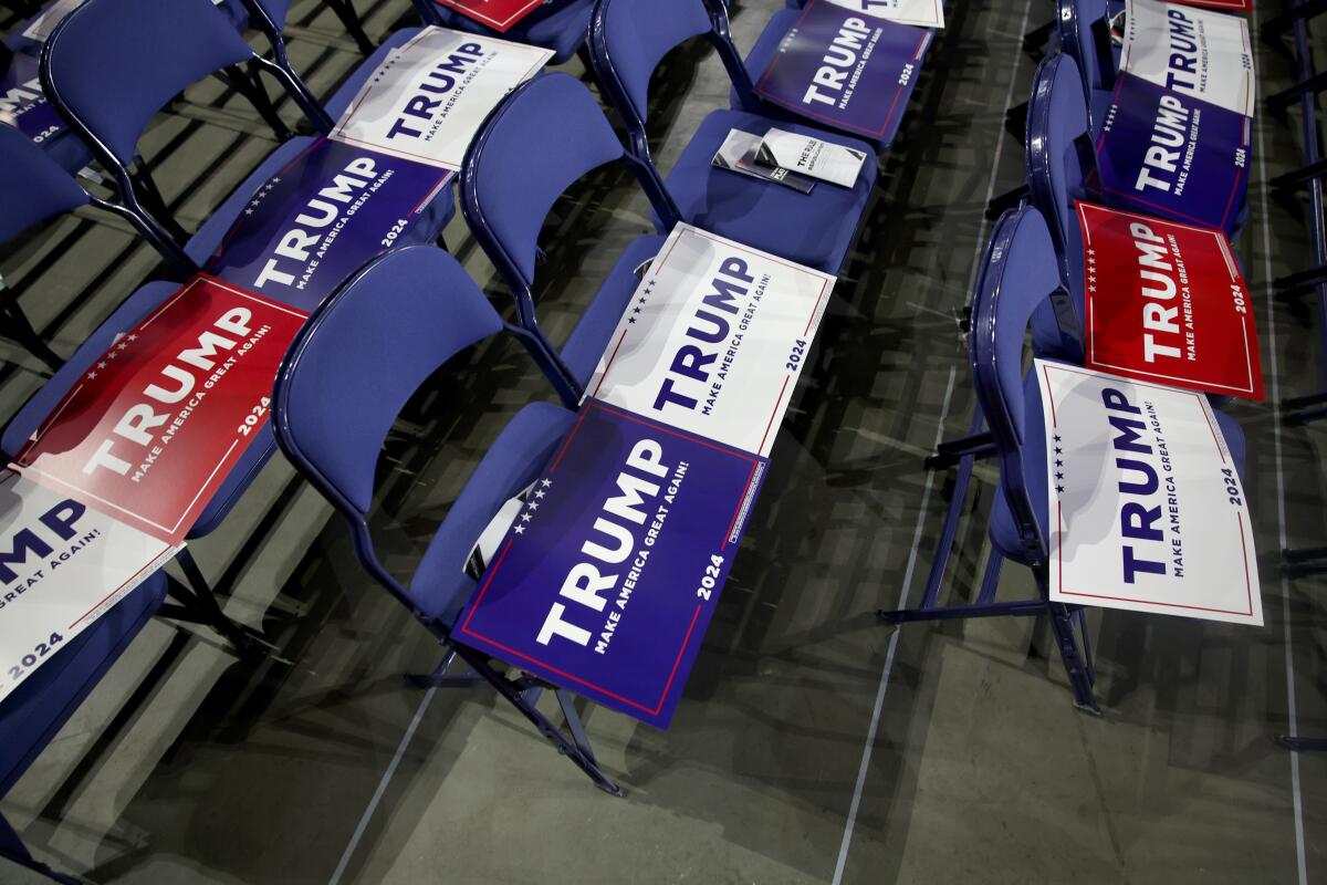 Trump signs are placed on the seats at the Republican National Convention in Milwaukee on Monday.