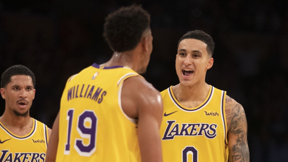 Lakers guard Josh Hart, left, and forward Kyle Kuzma, right, celebrate with Johnathan Williams, center, against the Spurs.