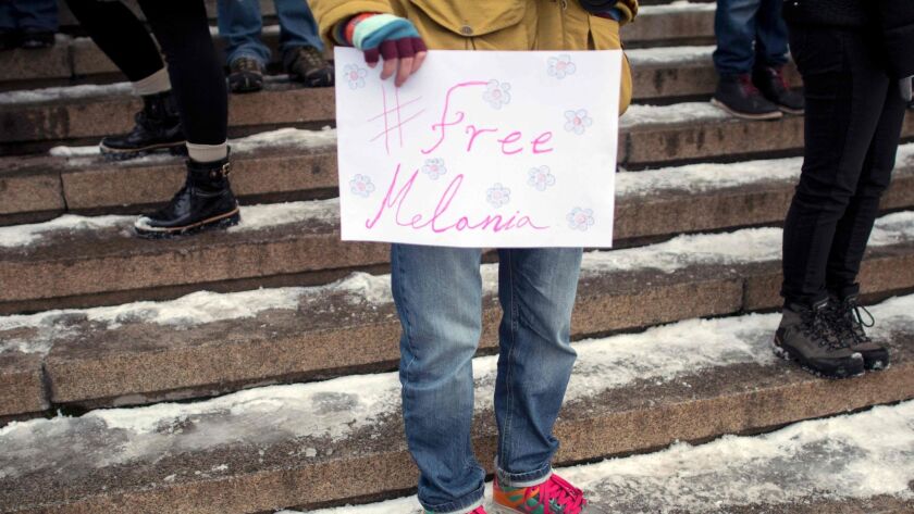 A person holds a placard reading "#Free Melania" during a rally in Sofia, Bulgaria on January 21.