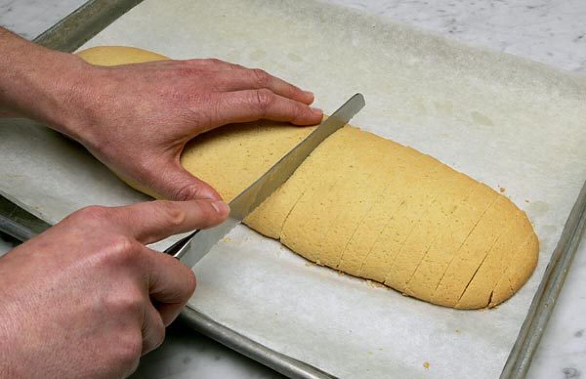 A knife cutting an American-style biscotti.