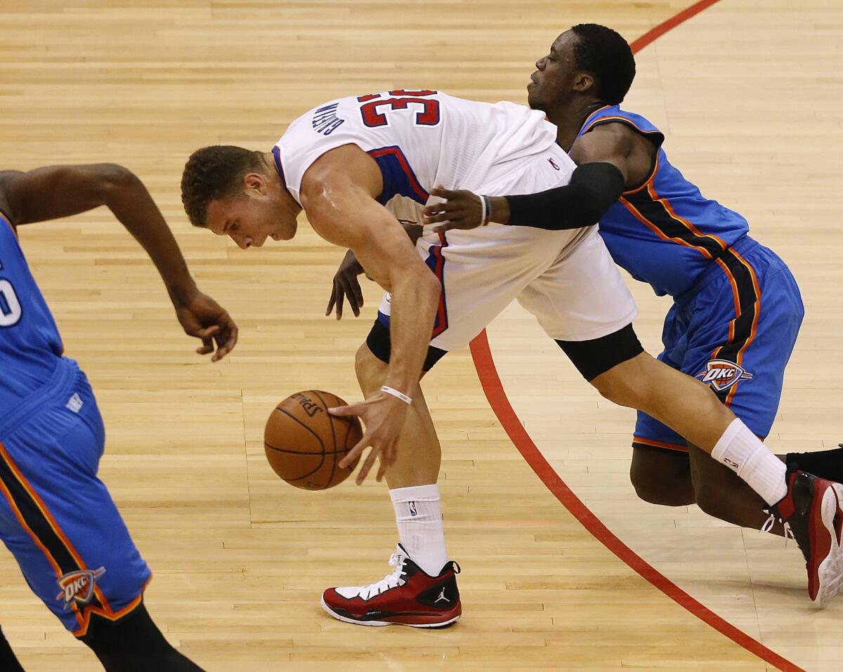 Clippers power forward Blake Griffin is fouled by Thunder guard Reggie Jackson after stealing the ball in the first half.