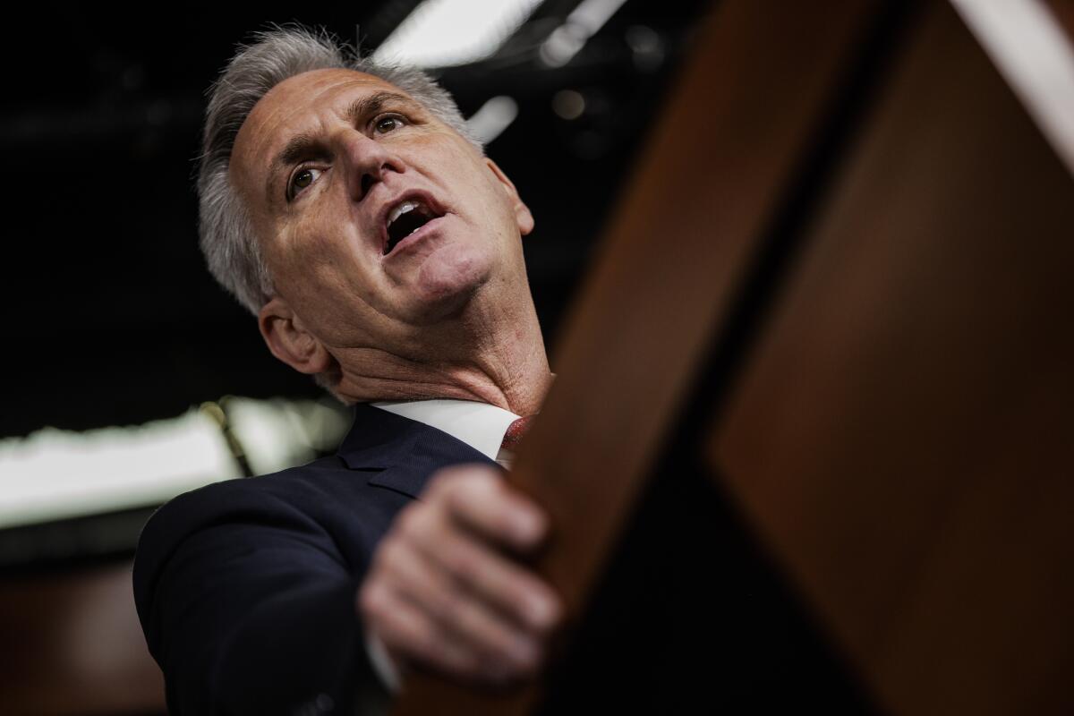 A gray-haired man speaks from a podium.