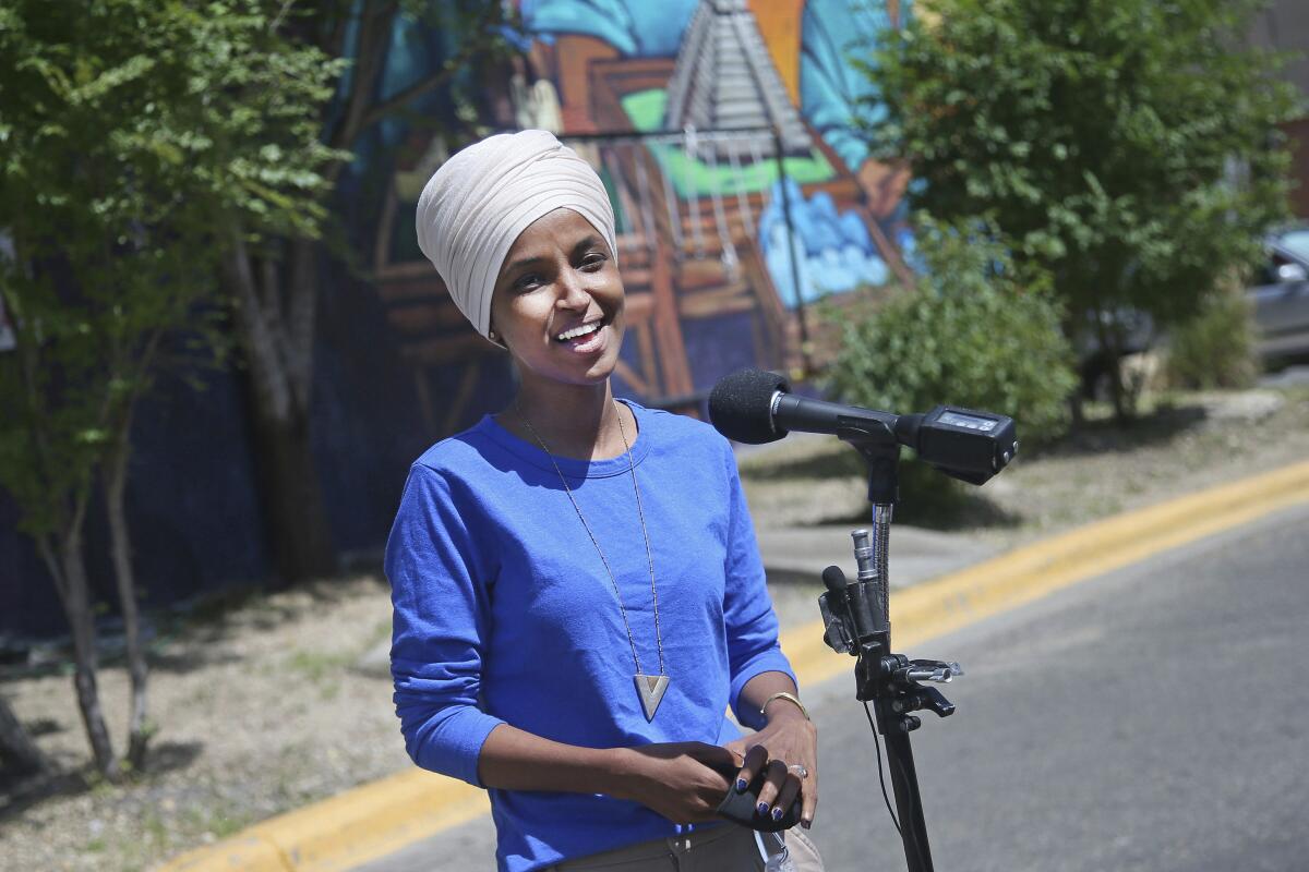 Democratic Rep. Ilhan Omar fields reporters' questions in Minneapolis on Tuesday.