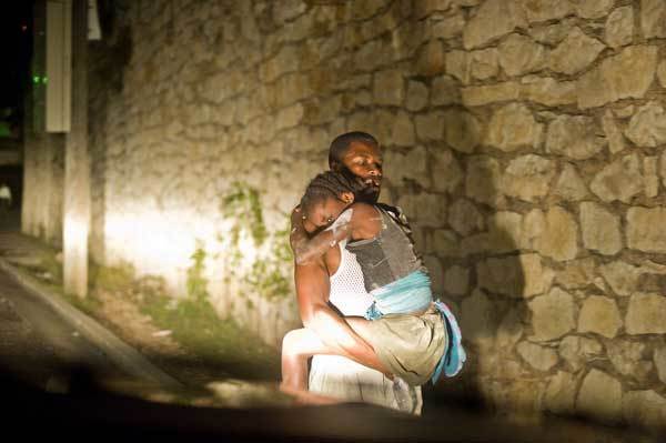 A father carries his duaghter after a major earthquake on January 12, 2010 in Port-au-Prince, Haiti. A 7.0 earthquake rocked Haiti today, followed by at least a dozen aftershocks, causing widespread devastation in the capital of Port-au-Prince.