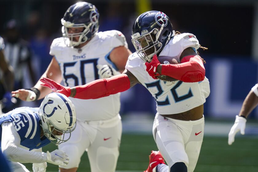 Tennessee Titans running back Derrick Henry pushes off Indianapolis Colts safety Rodney Thomas II in the first half of an NFL football game in Indianapolis, Fla., Sunday, Oct. 2, 2022. (AP Photo/Darron Cummings)