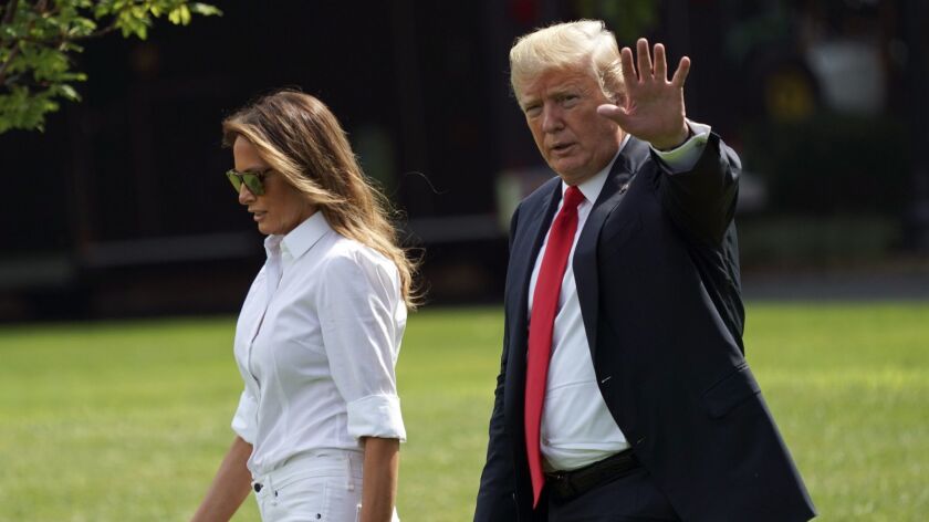 President Trump and First Lady Melania Trump walk on the White House's South Lawn to board Marine One as they depart for a weekend at his golf club in Bedminster, N.J.